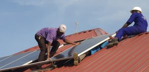 Installing solar panels for solar water pumping system in Uganda